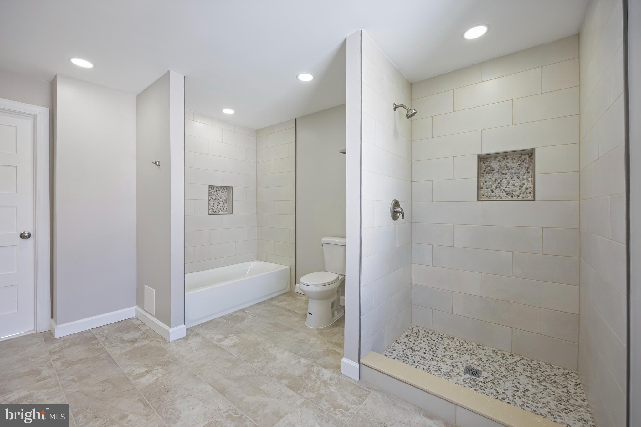 3908 Primrose Avenue Baltimore, MD 21215 - Photo 11 of 19 a bathroom with a shower and a toilet