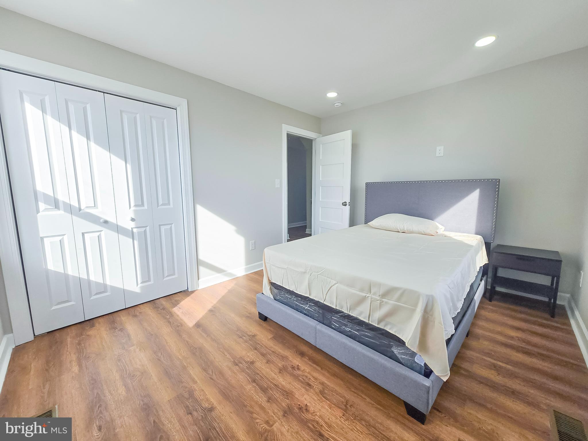 3908 Primrose Avenue Baltimore, MD 21215 - Photo 13 of 19 a large bed sitting in a spacious bedroom next to a window