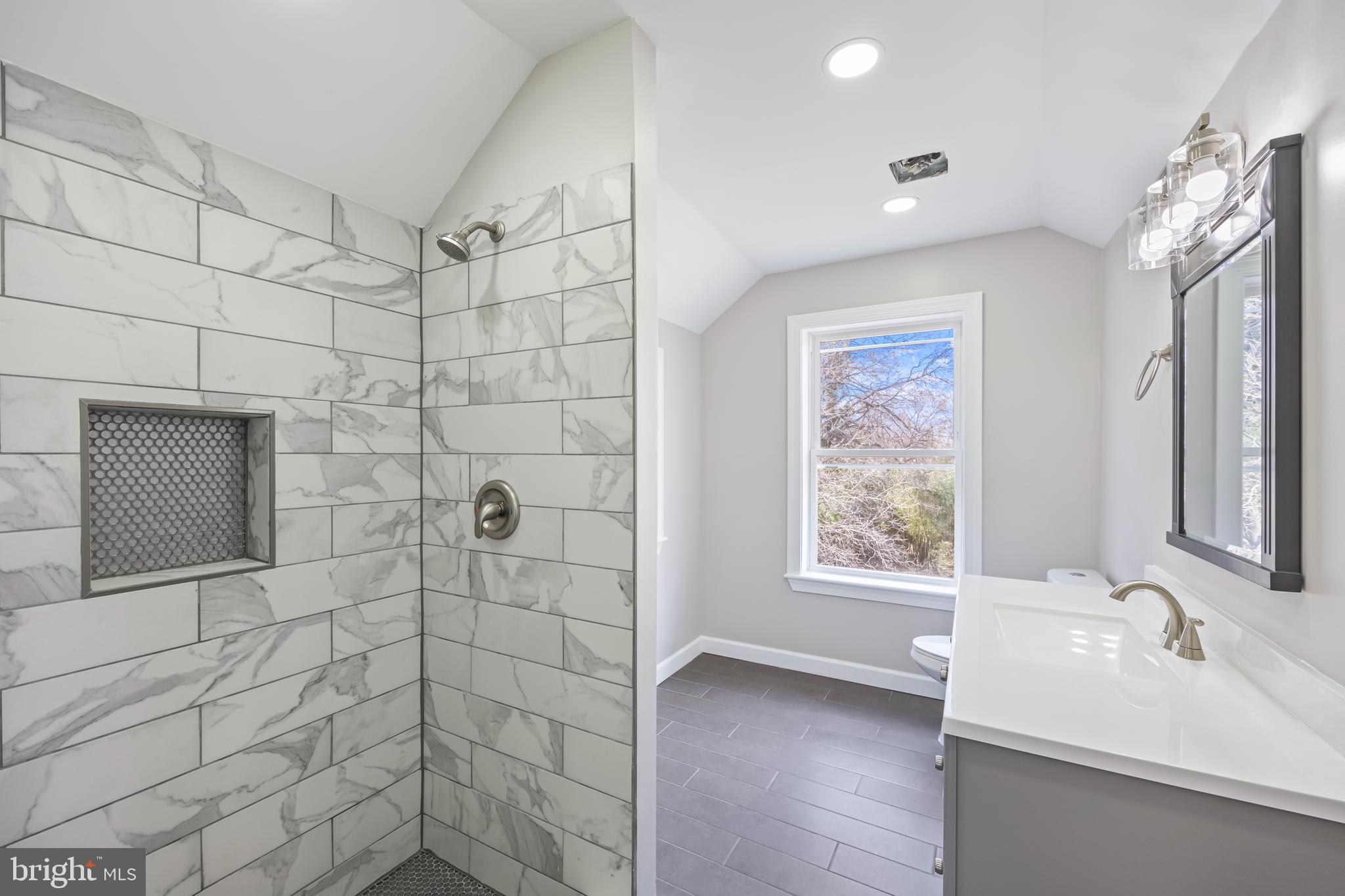 3908 Primrose Avenue Baltimore, MD 21215 - Photo 15 of 19 a bathroom with a sink a toilet and shower