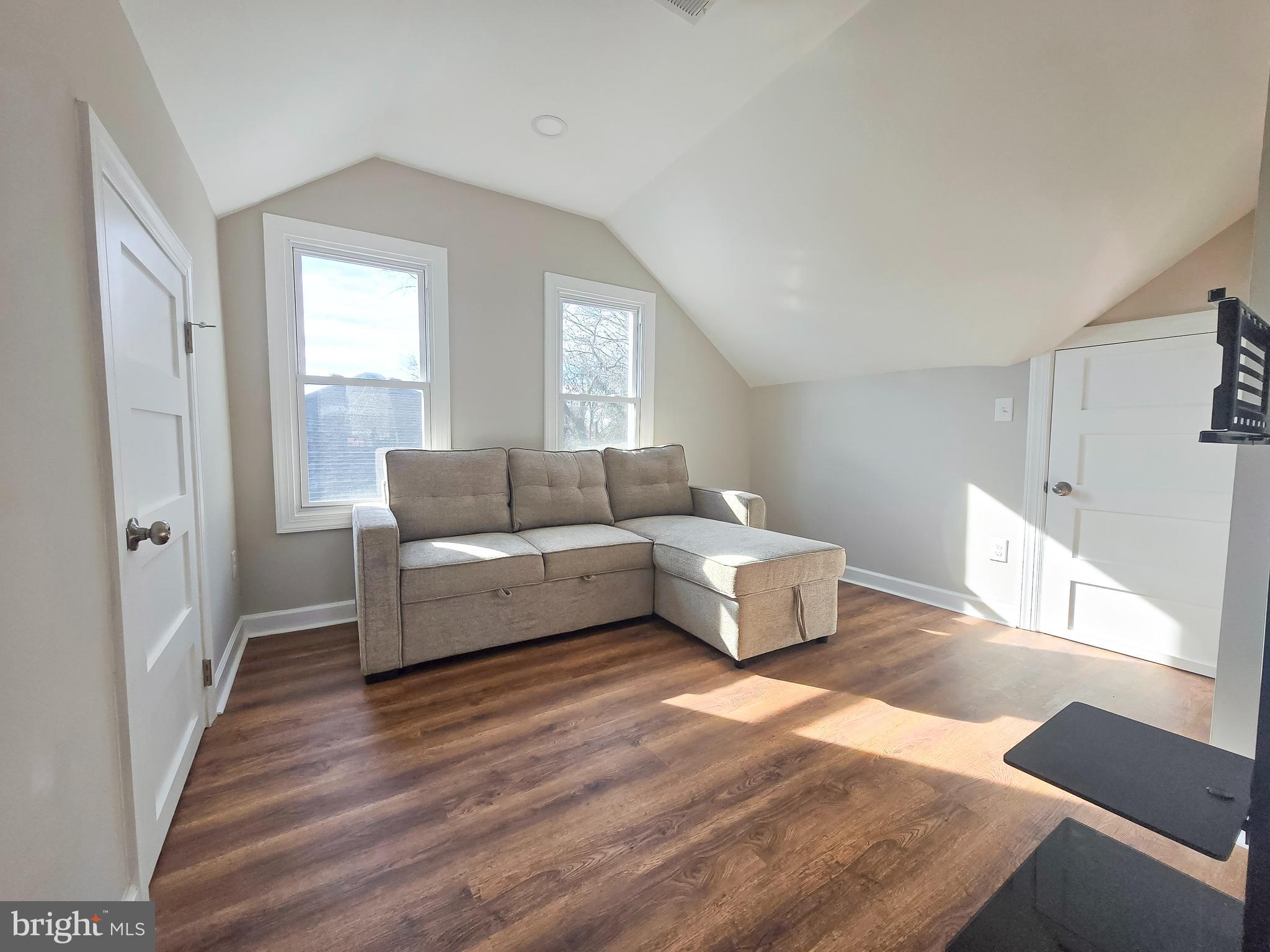 3908 Primrose Avenue Baltimore, MD 21215 - Photo 17 of 19 a living room with furniture and a wooden floor