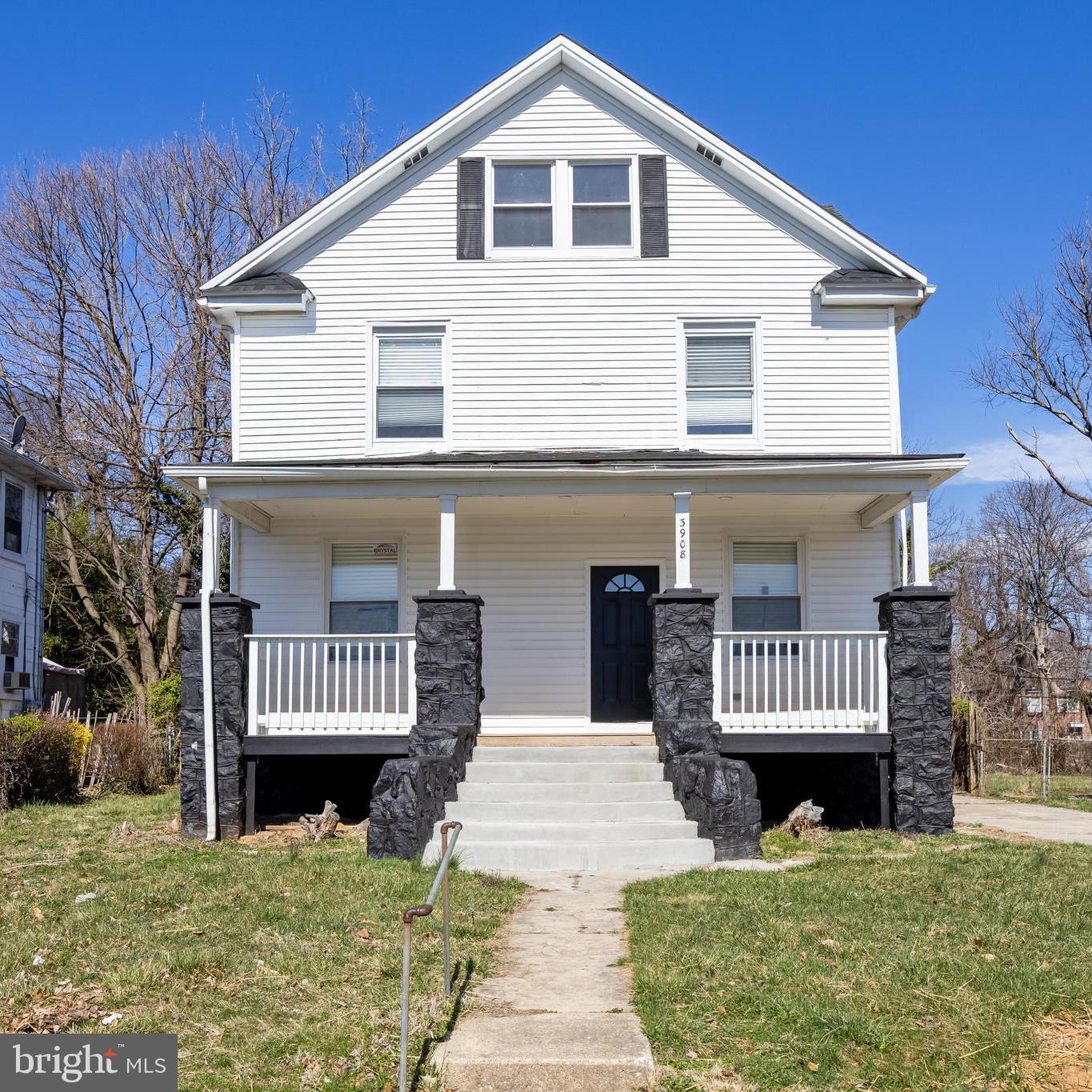 3908 Primrose Avenue Baltimore, MD 21215 - Photo 2 of 19 a front view of a house with a garden