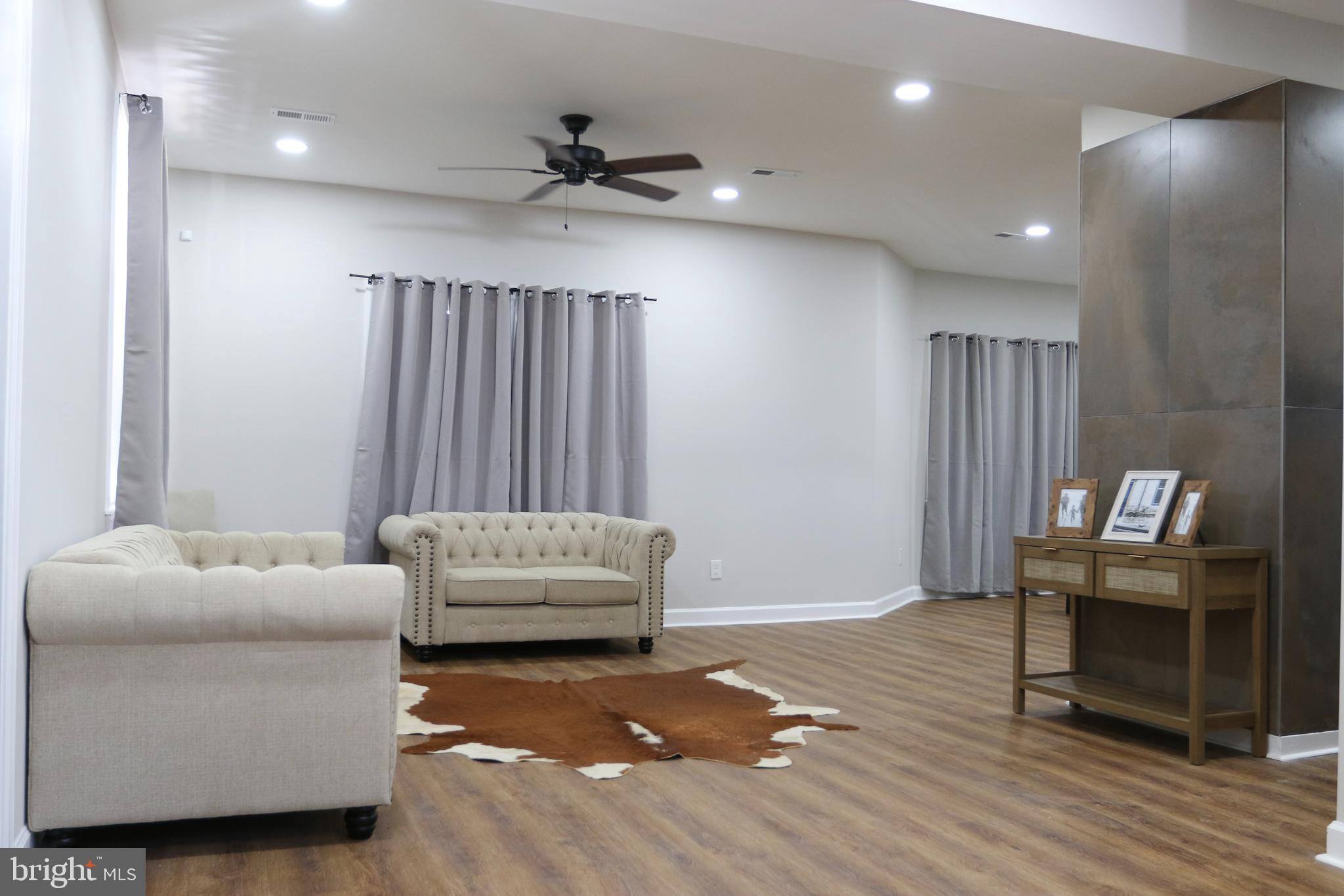 3908 Primrose Avenue Baltimore, MD 21215 - Photo 4 of 19 a living room with furniture and a wooden floor