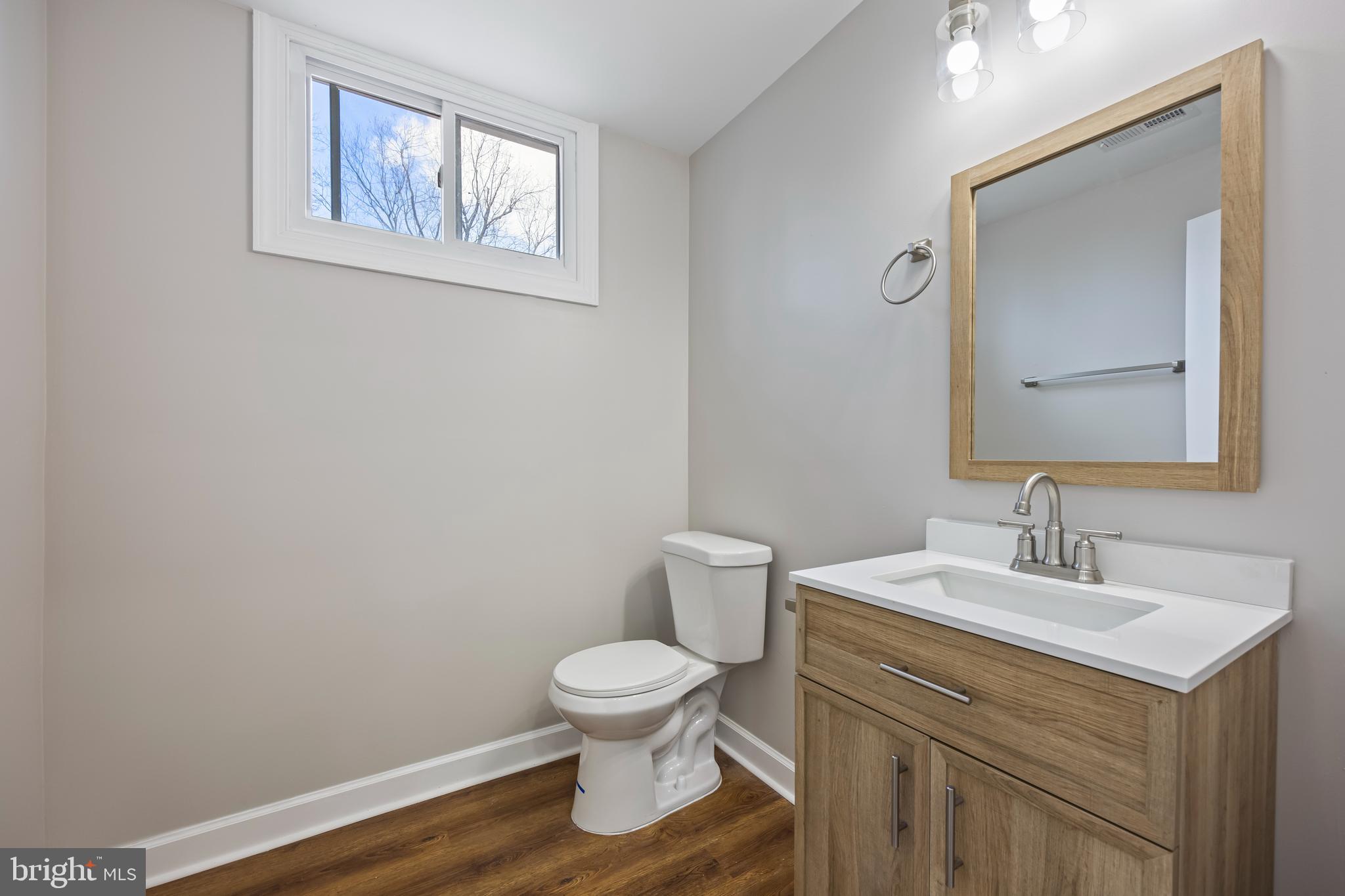 3908 Primrose Avenue Baltimore, MD 21215 - Photo 9 of 19 a bathroom with a toilet sink and mirror