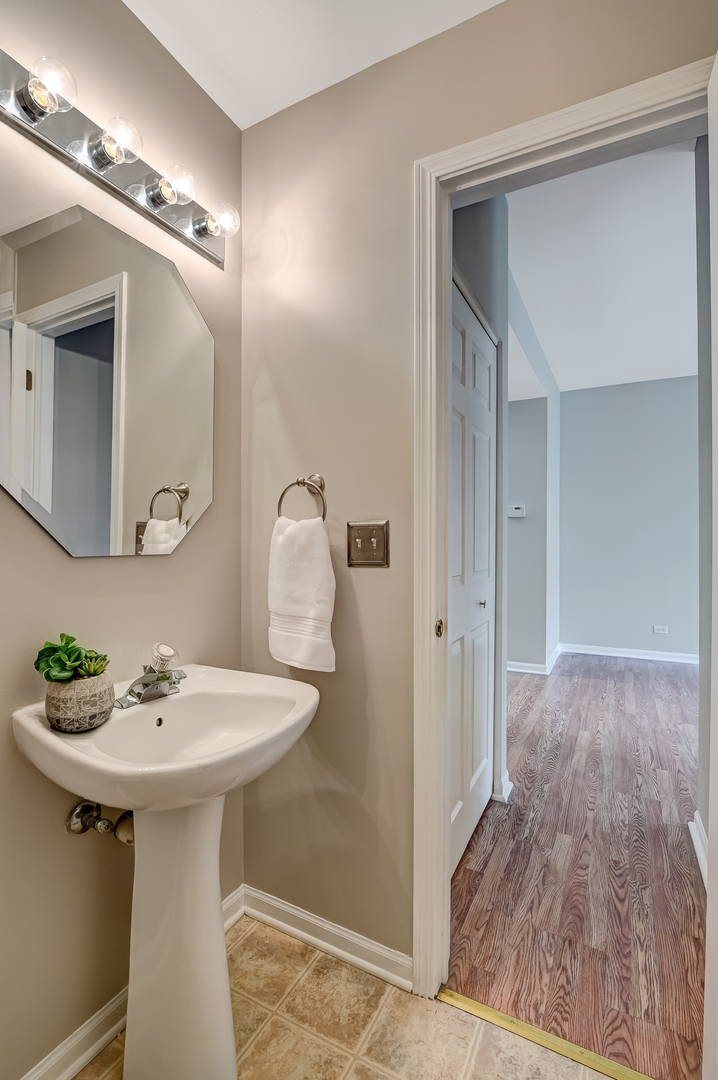 118 Enclave Circle, Unit C Bolingbrook, IL 60440 - Photo 13 of 27 a bathroom with a sink and a mirror