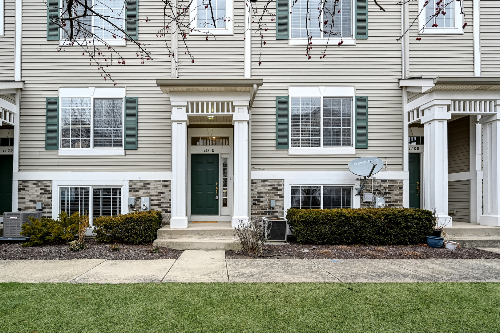 118 Enclave Circle, Unit C Bolingbrook, IL 60440 - Photo 2 of 27 a front view of a house with a yard
