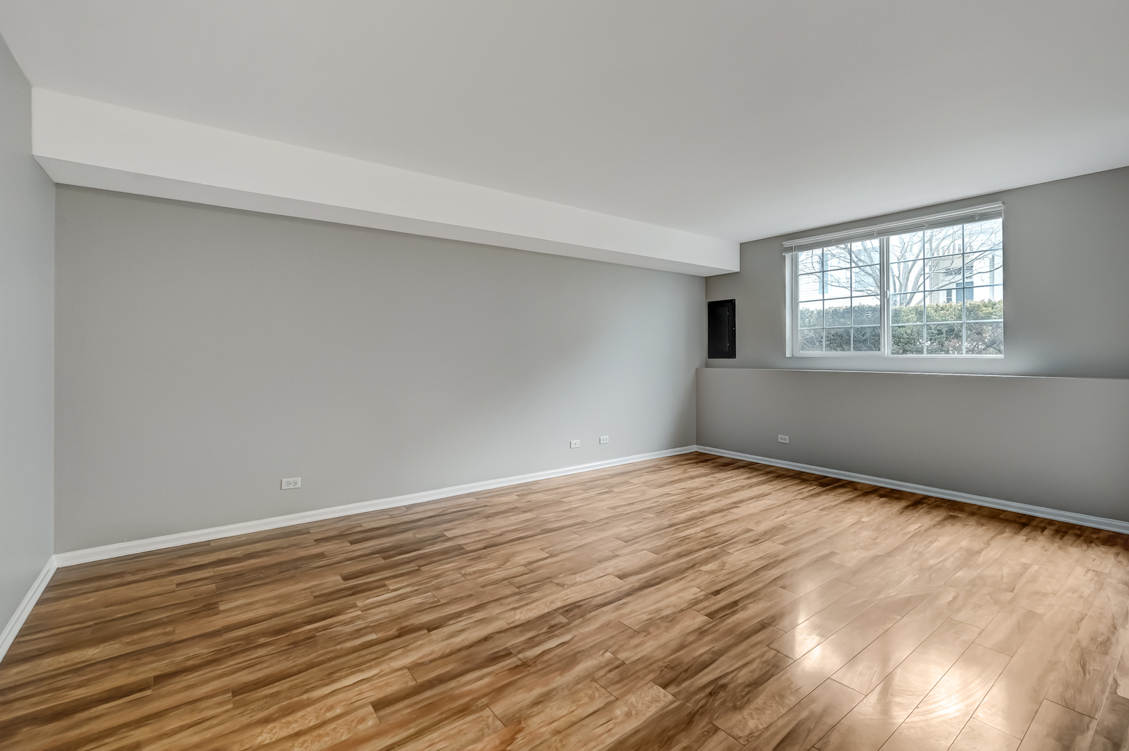 118 Enclave Circle, Unit C Bolingbrook, IL 60440 - Photo 21 of 27 a view of an empty room with wooden floor and a window