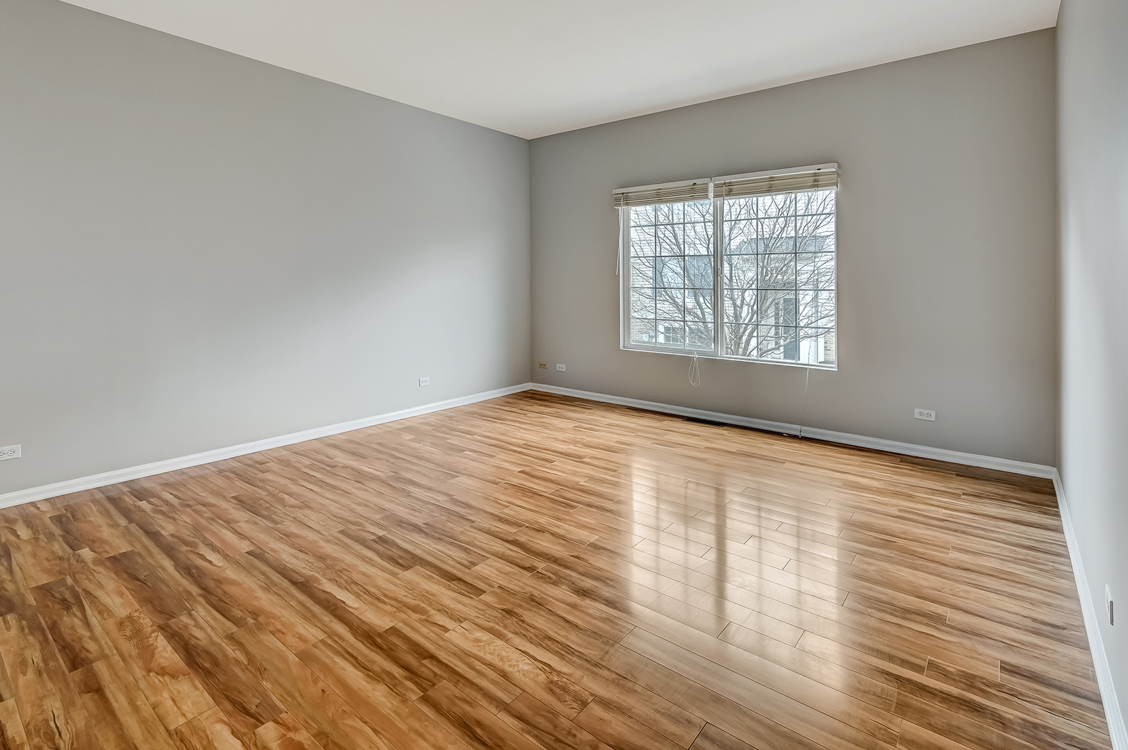118 Enclave Circle, Unit C Bolingbrook, IL 60440 - Photo 3 of 27 a view of an empty room with wooden floor and a window