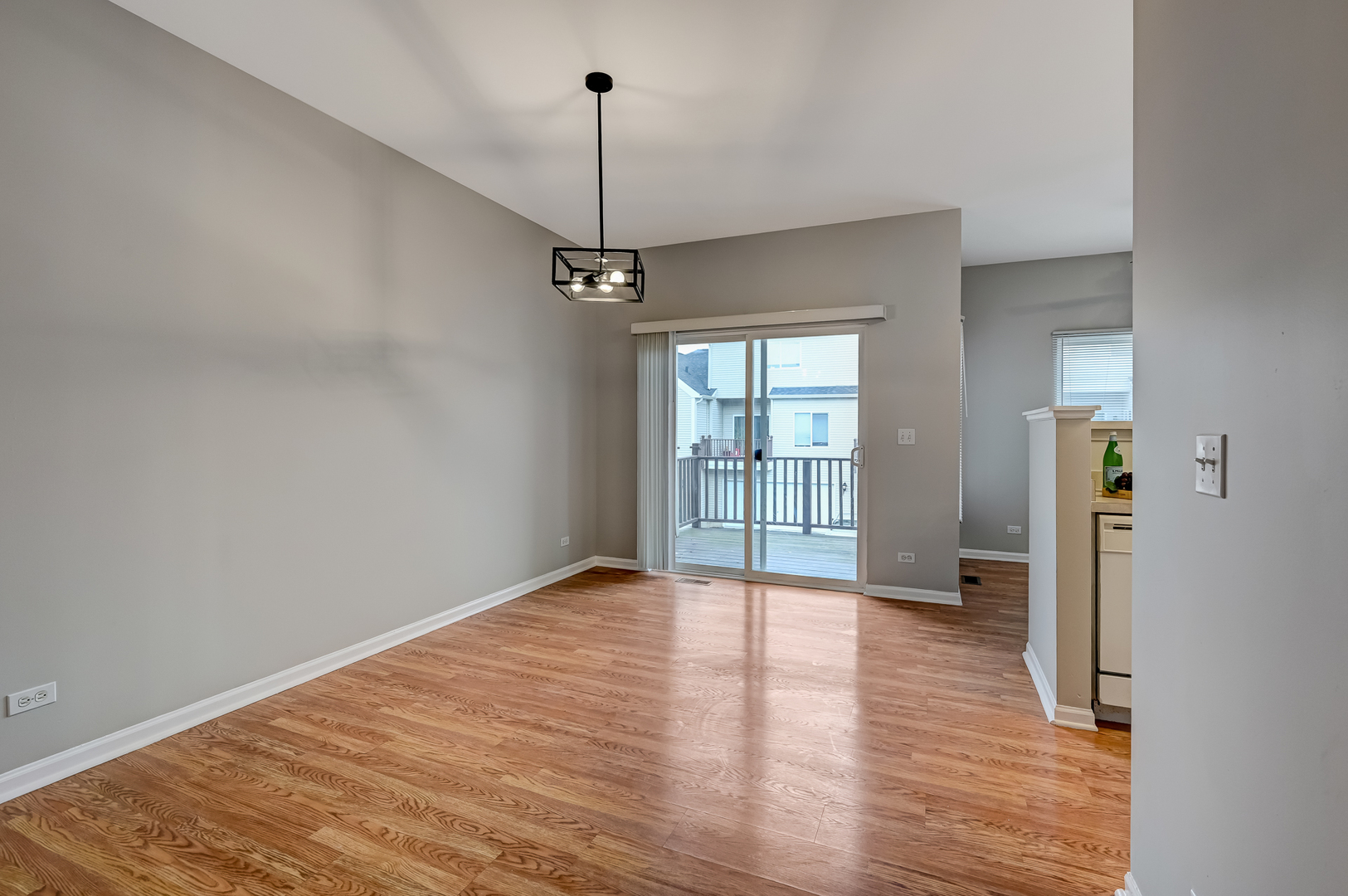 118 Enclave Circle, Unit C Bolingbrook, IL 60440 - Photo 5 of 27 a view of an empty room with window and wooden floor