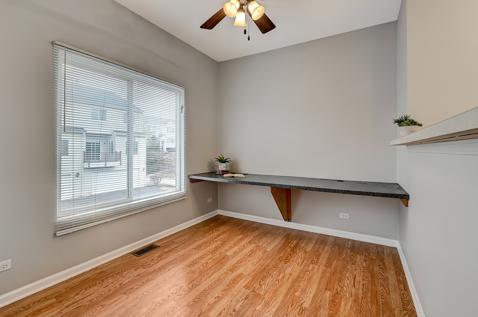 118 Enclave Circle, Unit C Bolingbrook, IL 60440 - Photo 10 of 27 an empty room with wooden floor and windows