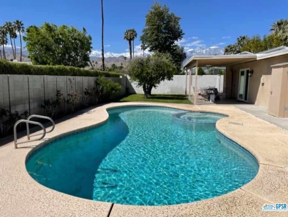 a view of a swimming pool with a patio