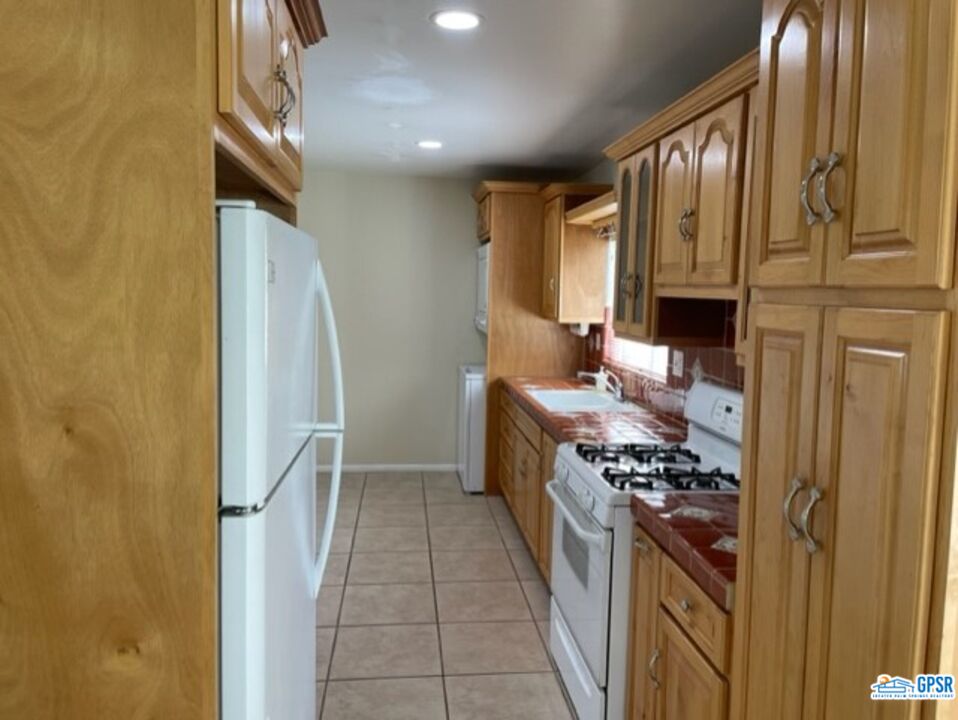 70161 Chappel Road Rancho Mirage, CA 92270 - Photo 5 of 20 a kitchen with stainless steel appliances granite countertop a refrigerator and a stove