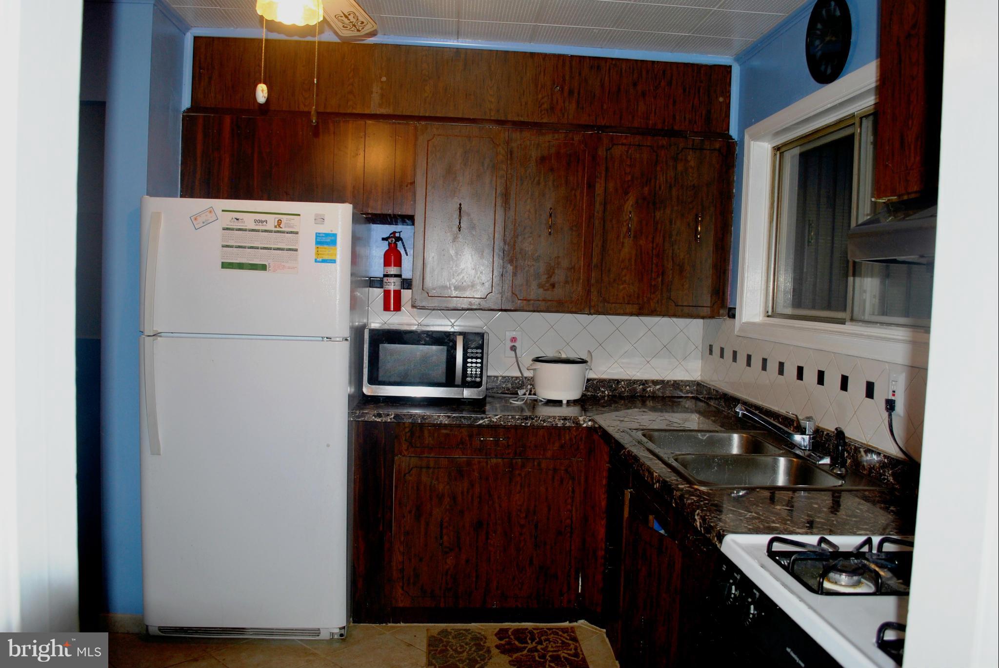 1001 Hallimont Road Catonsville, MD 21228 - Photo 14 of 19 a kitchen with a refrigerator and a stove top oven