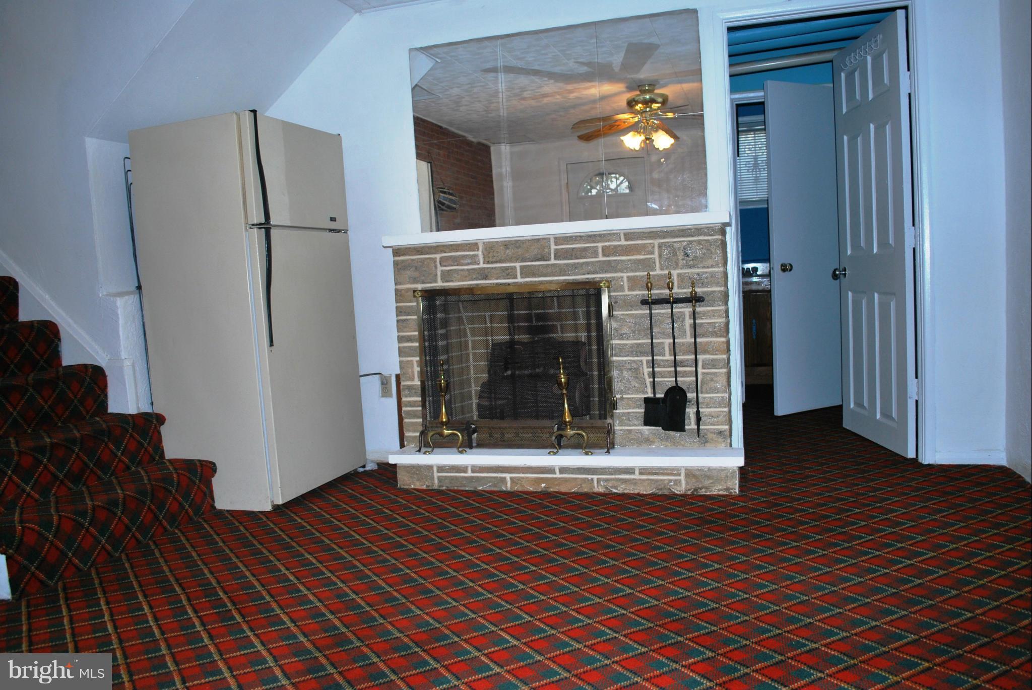 1001 Hallimont Road Catonsville, MD 21228 - Photo 16 of 19 a view of a livingroom with wooden floor and a fireplace