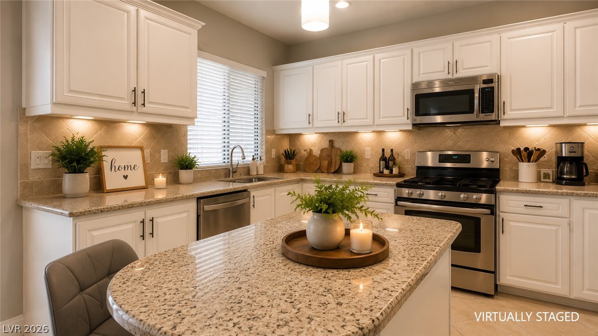 87 Tall Ruff Drive Las Vegas, NV 89148 - Photo 49 of 71 Granite counters and stainless steel appliances elevate this well-appointed kitchen.