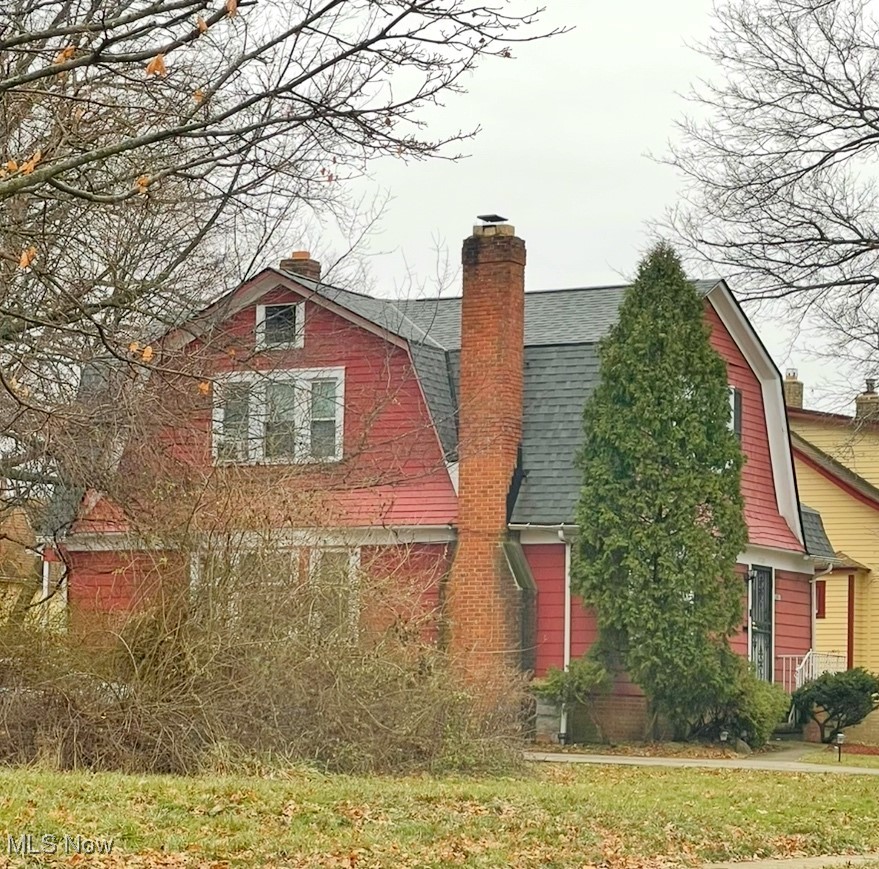 1001 Yellowstone Road Cleveland Heights, OH 44121 - Photo 2 of 2 View of front facade featuring a shingled roof, a chimney, and a gambrel roof