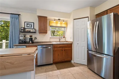 a kitchen with stainless steel appliances a refrigerator sink and cabinets