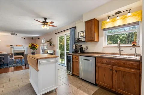 a kitchen with kitchen island a sink a stove and a refrigerator