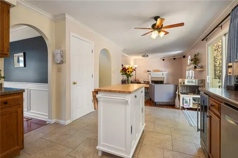 a view of kitchen with sink refrigerator dining table and chairs
