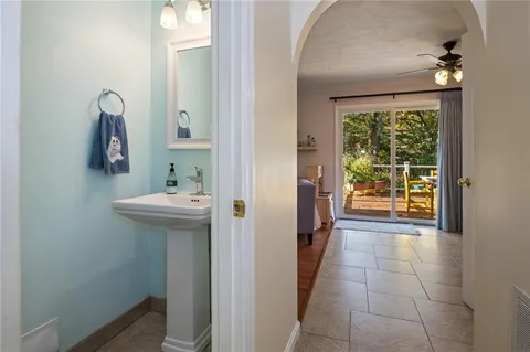 a bathroom with a sink a mirror and next to a window