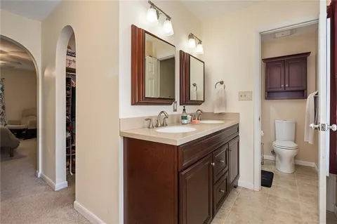 a bathroom with a sink vanity toilet and a mirror