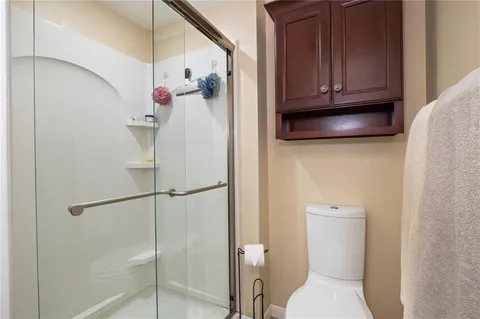 a bathroom with a toilet a sink and a shower