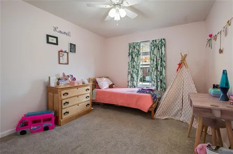 a bedroom with furniture and a window