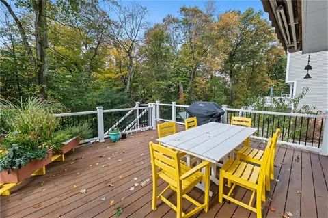 a view of a deck with two chair and a potted plant