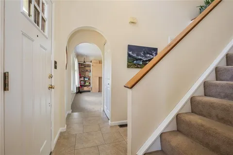 a view of entryway and hall with a couch