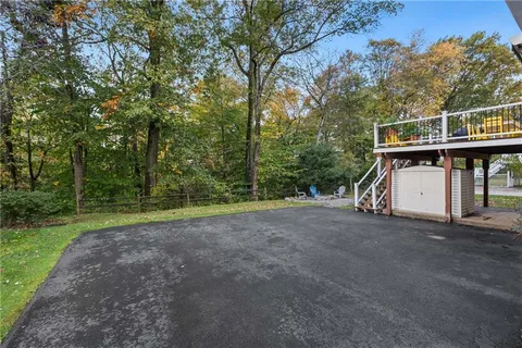 a view of a white house with a street