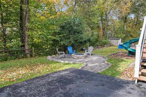 a view of a house with backyard and sitting area