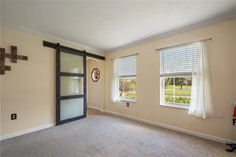 an empty room with windows and closet