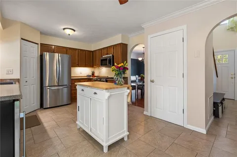 a kitchen with a refrigerator sink and cabinets