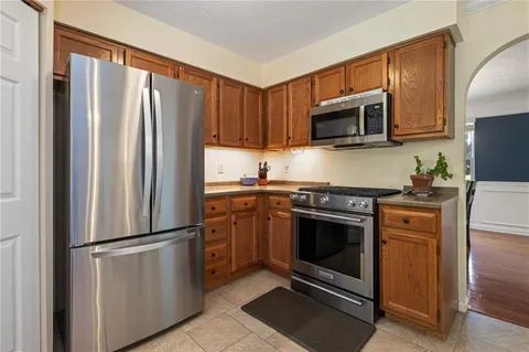 a kitchen with stainless steel appliances granite countertop a refrigerator stove and microwave