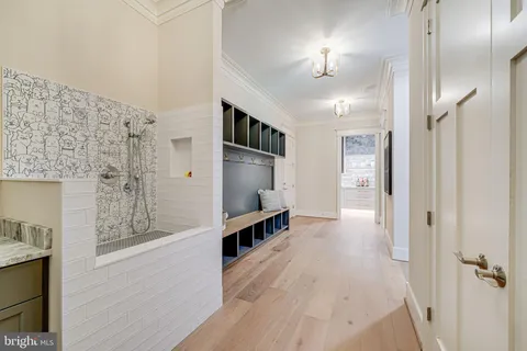 a view of a hallway with wooden floor and staircase