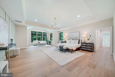 a spacious bedroom with a large bed and a large window