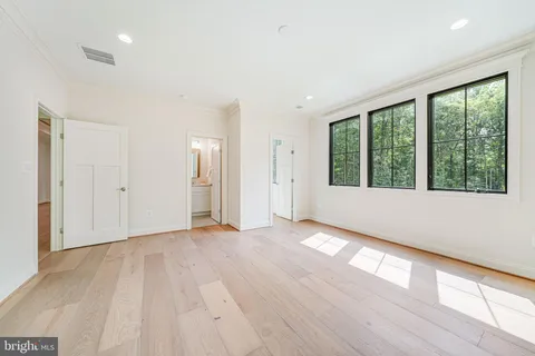 a room with lots of furniture and a wooden floor