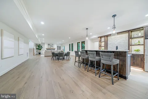 a kitchen with kitchen island a large window cabinets a sink and stainless steel appliances