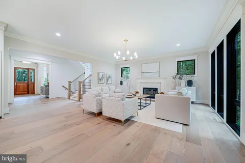 a living room with fireplace furniture and a wooden floor