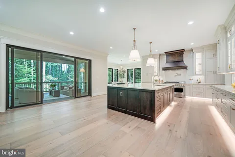 a large open kitchen with a large window a oven and a sink