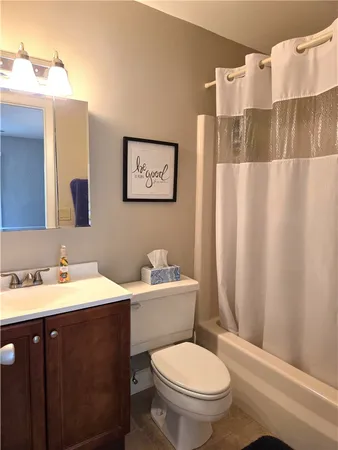 a bathroom with a toilet a sink and a mirror