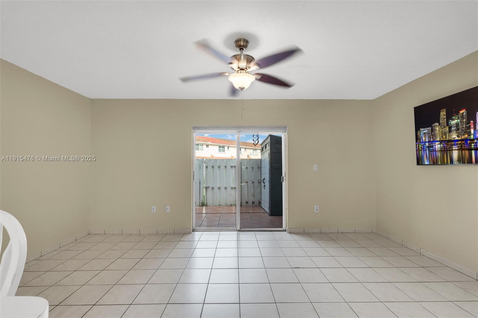 6263 Southwest 139th Avenue Miami, FL 33183 - Photo 11 of 38 a view of an empty room with window and chandelier fan