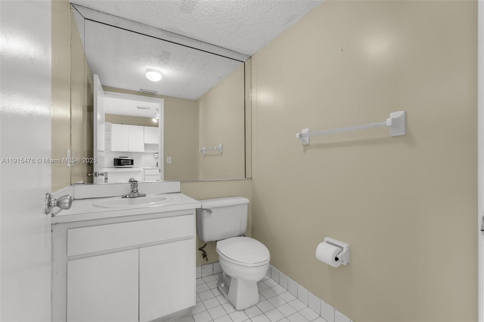 6263 Southwest 139th Avenue Miami, FL 33183 - Photo 14 of 38 a bathroom with a toilet a sink a mirror and vanity