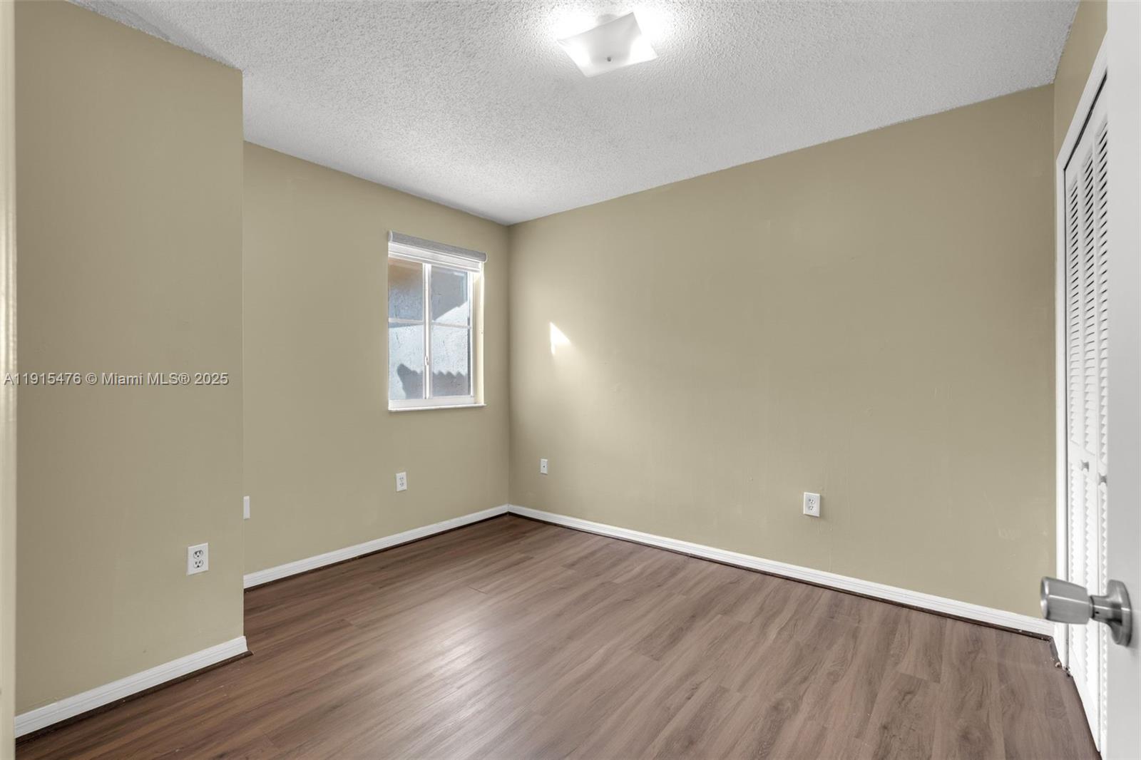 6263 Southwest 139th Avenue Miami, FL 33183 - Photo 21 of 38 an empty room with wooden floor and windows