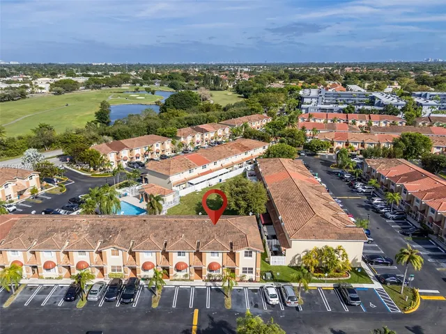 an aerial view of residential houses with outdoor space
