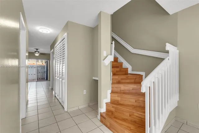 a view of a hallway with entryway and wooden floor