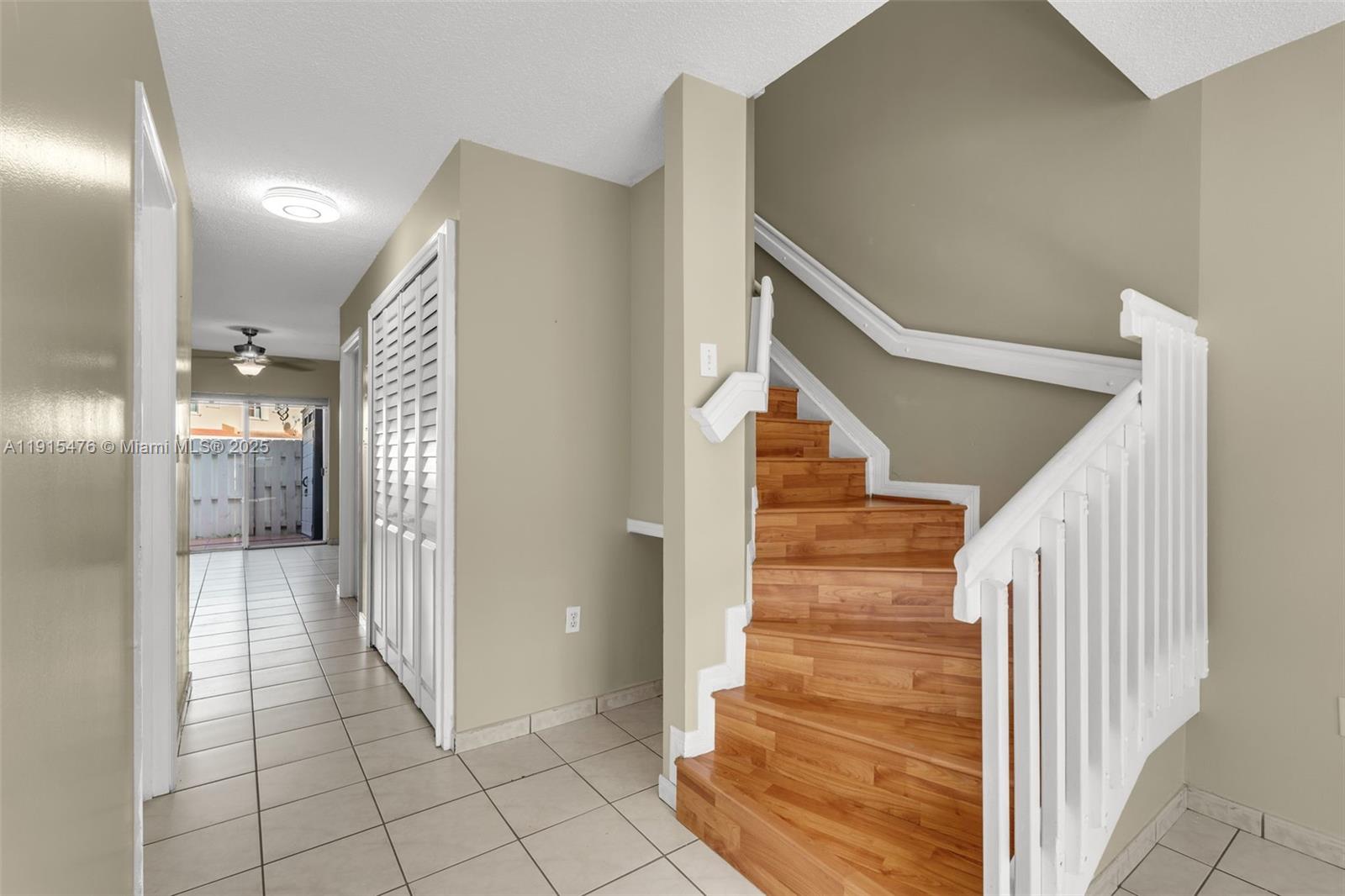 6263 Southwest 139th Avenue Miami, FL 33183 - Photo 6 of 38 a view of a hallway with entryway and wooden floor