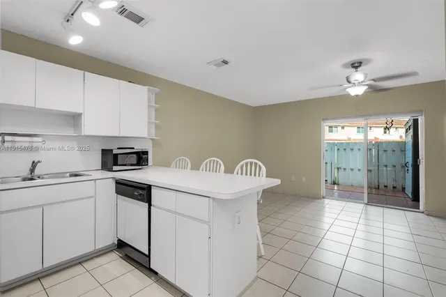 a kitchen with a sink cabinets and appliances