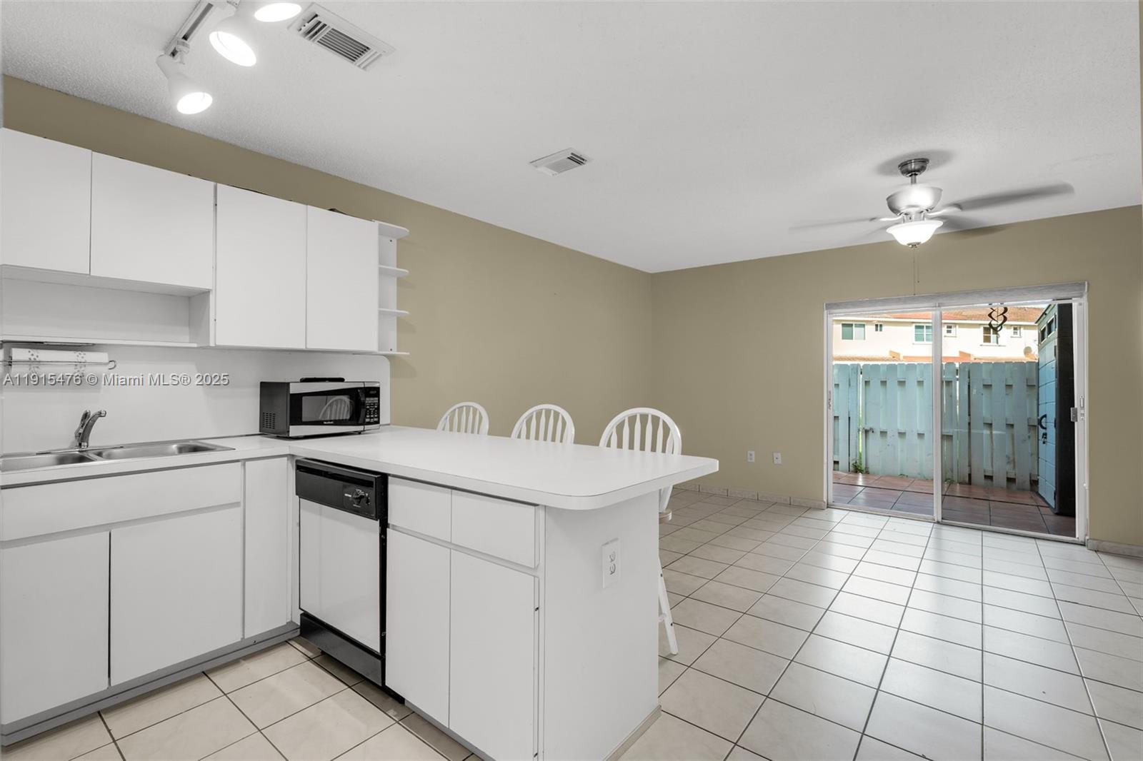 6263 Southwest 139th Avenue Miami, FL 33183 - Photo 7 of 38 a kitchen with a sink cabinets and appliances