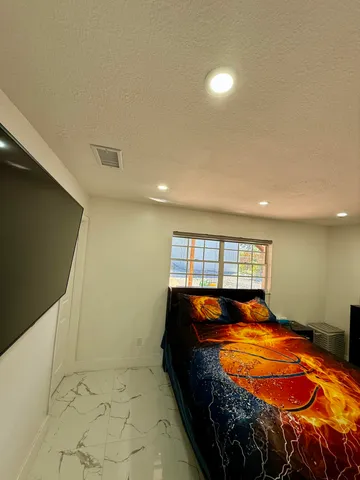 a bedroom with a bed and a window