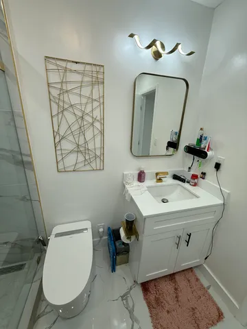 a bathroom with a toilet sink and mirror